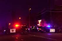 Law enforcement vehicles from several agencies block a street near the scene of a shooting in S ...