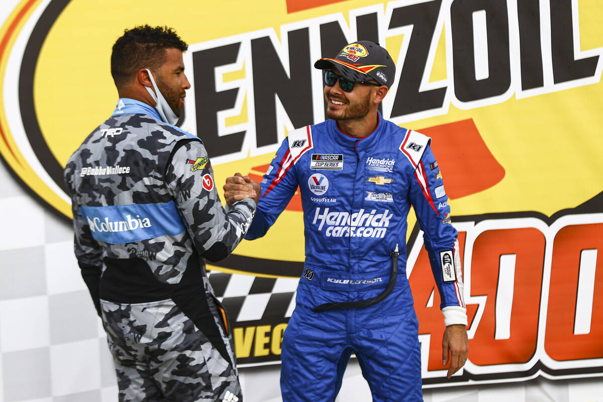 Bubba Wallace, left, congratulates Kyle Larson on his win in the NASCAR Cup Series Pennzoil 400 ...