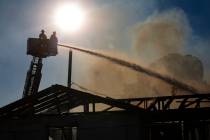 Las Vegas firefighters respond to the scene of a vacant building on fire at Maryland Parkway an ...