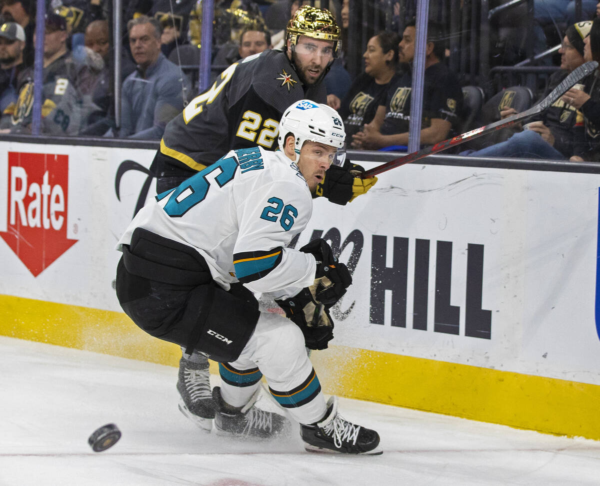 Golden Knights center Michael Amadio (22) and San Jose Sharks center Jasper Weatherby (26) figh ...