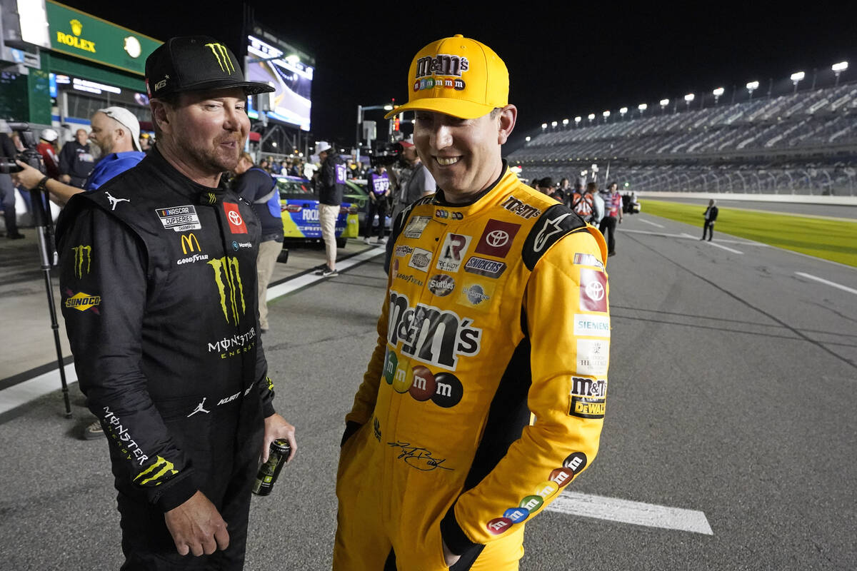 Kurt Busch, left, and Kyle Busch talk on pit road during qualifying for the NASCAR Daytona 500 ...