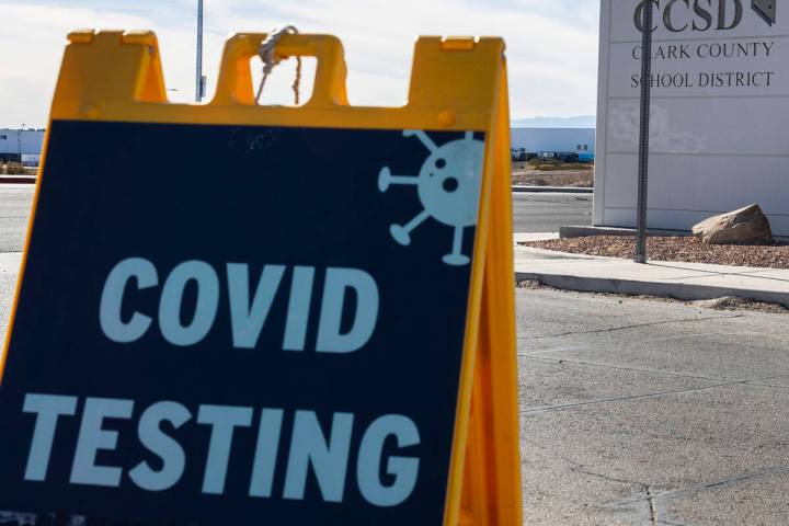 A COVID testing sign is displayed at the main gate of the Clark County School District building ...