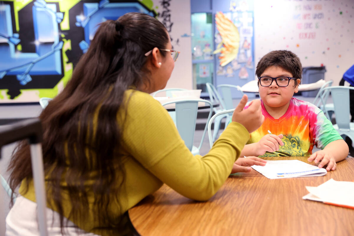 Jerania Mancilla, assistant teacher for resource room, works with fourth grader Daniel Gomez Ro ...