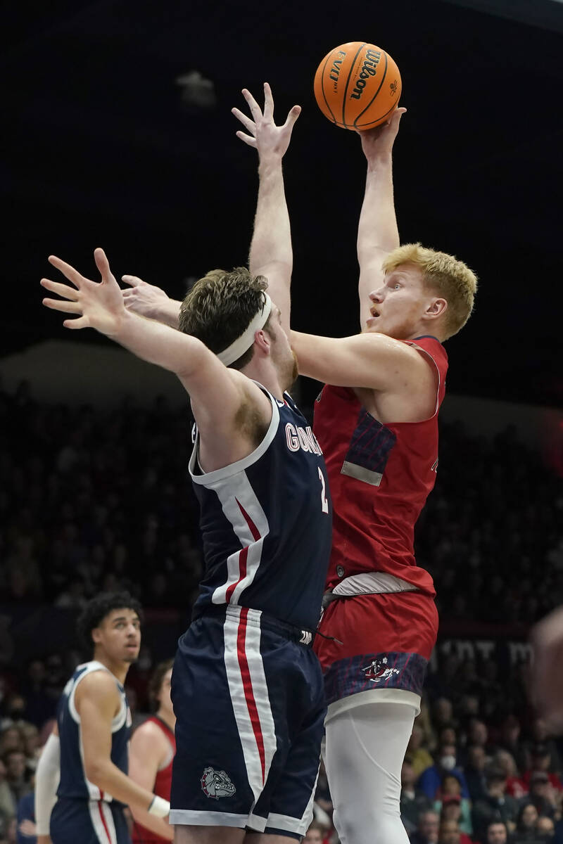 Saint Mary's forward Matthias Tass, right, shoots over Gonzaga forward Drew Timme during the se ...