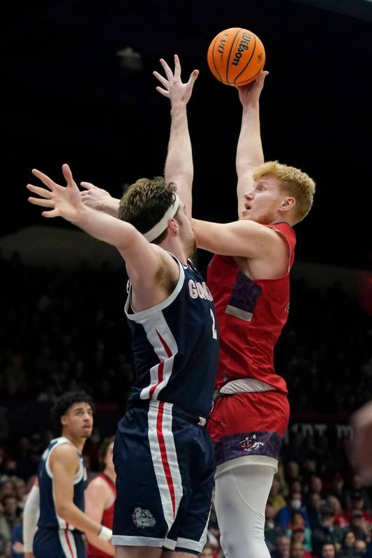 Saint Mary's forward Matthias Tass, right, shoots over Gonzaga forward Drew Timme during the se ...