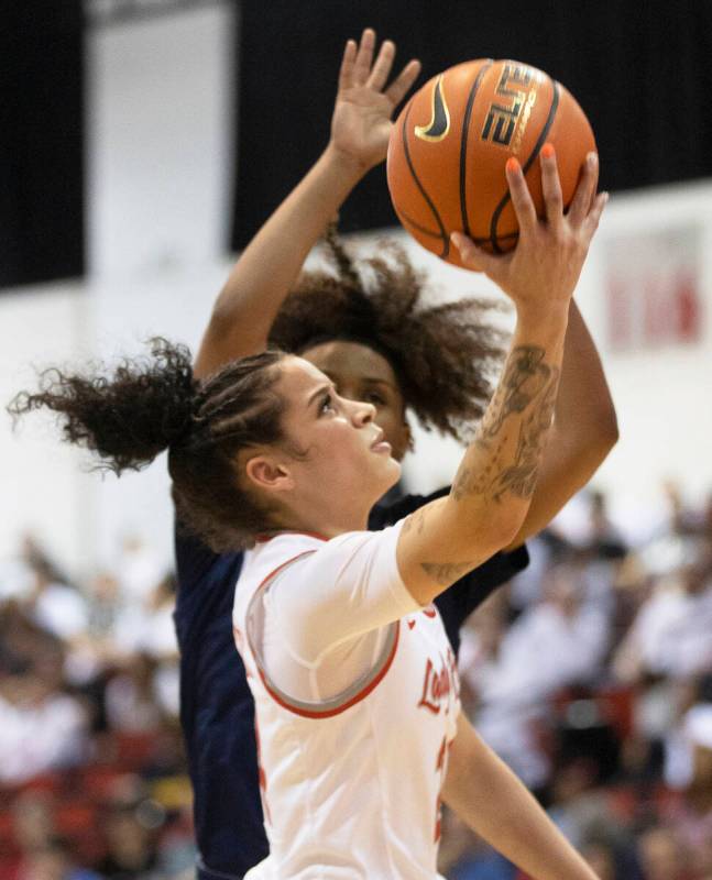 UNLV Lady Rebels guard Essence Booker (24) drives past a Nevada Wolf Pack defender in the secon ...