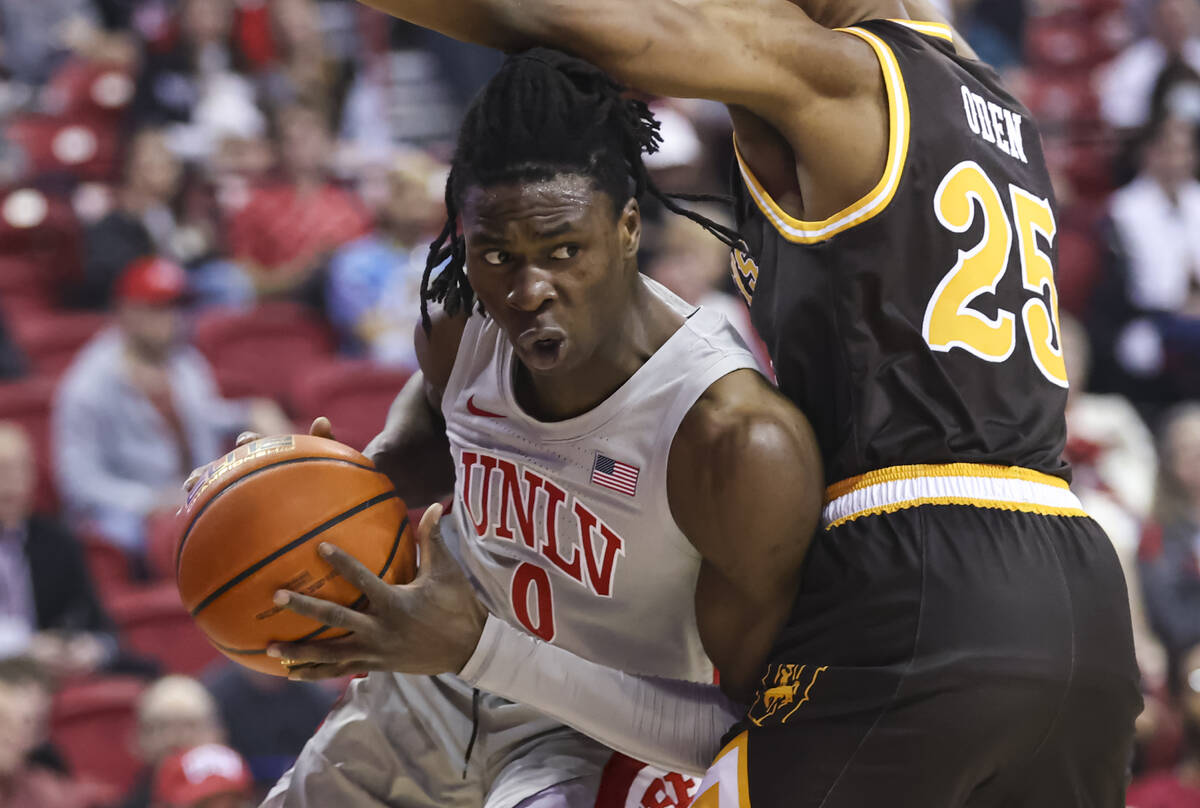 UNLV Rebels forward Victor Iwuakor (0) drives to the basket against Wyoming Cowboys forward Jer ...