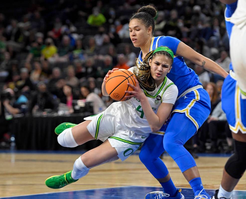 Oregon guard Endyia Rogers (4) is fouled as she drives to the basket against UCLA guard Jaelynn ...