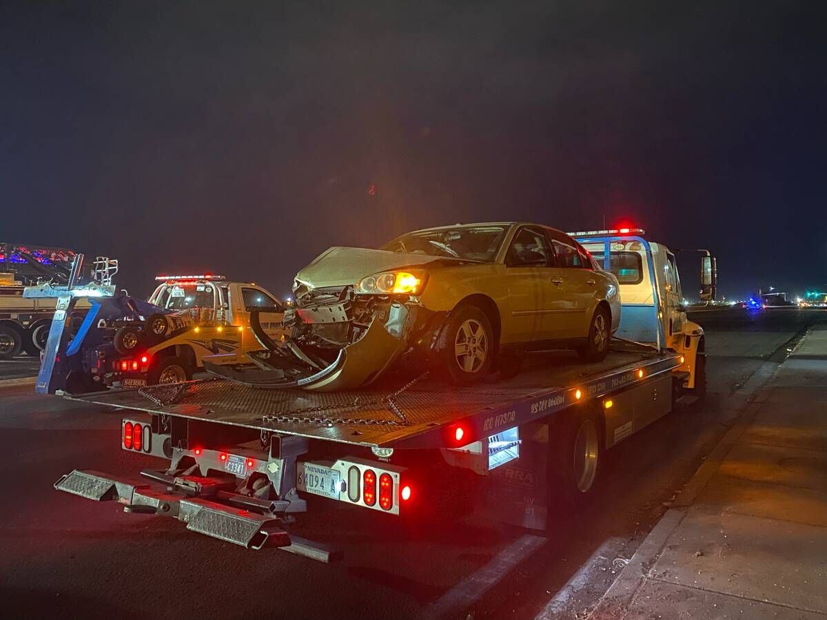 A vehicle that was involved in a six-vehicle crash is towed away from the scene of the fatal cr ...