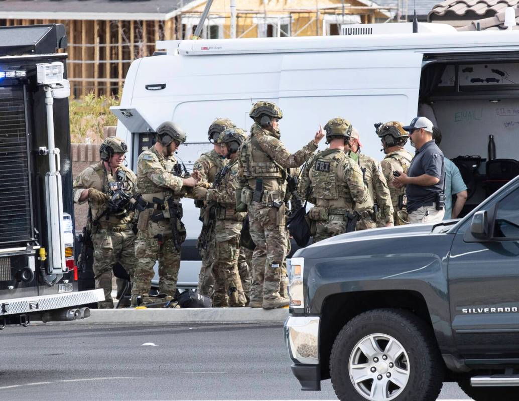 A SWAT team arrives where Las Vegas police are assisting the FBI in a barricade and shooting si ...