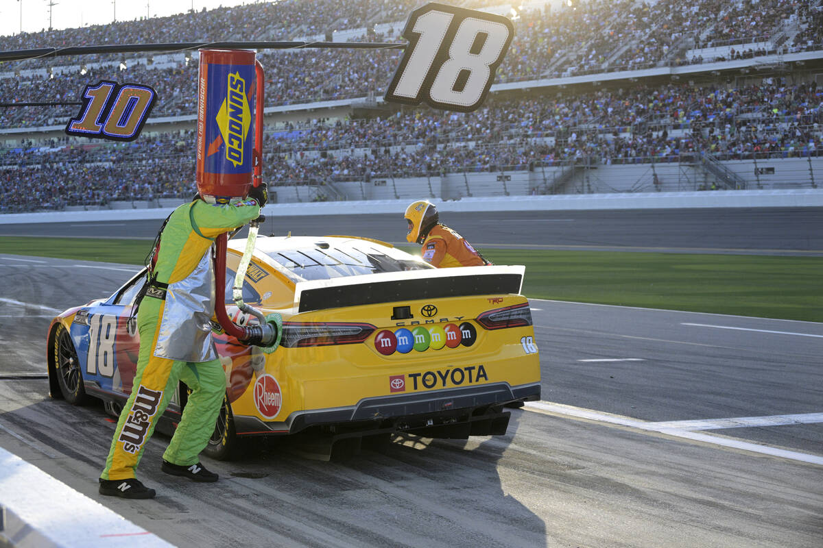 Kyle Busch (18) makes a pit stop during the NASCAR Daytona 500 auto race at Daytona Internation ...