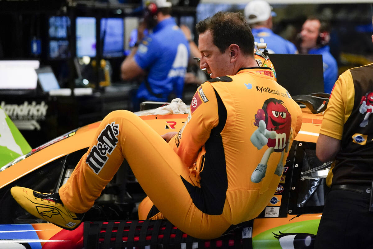 Kyle Busch climbs out of his car after NASCAR Daytona 500 auto race practice at Daytona Interna ...