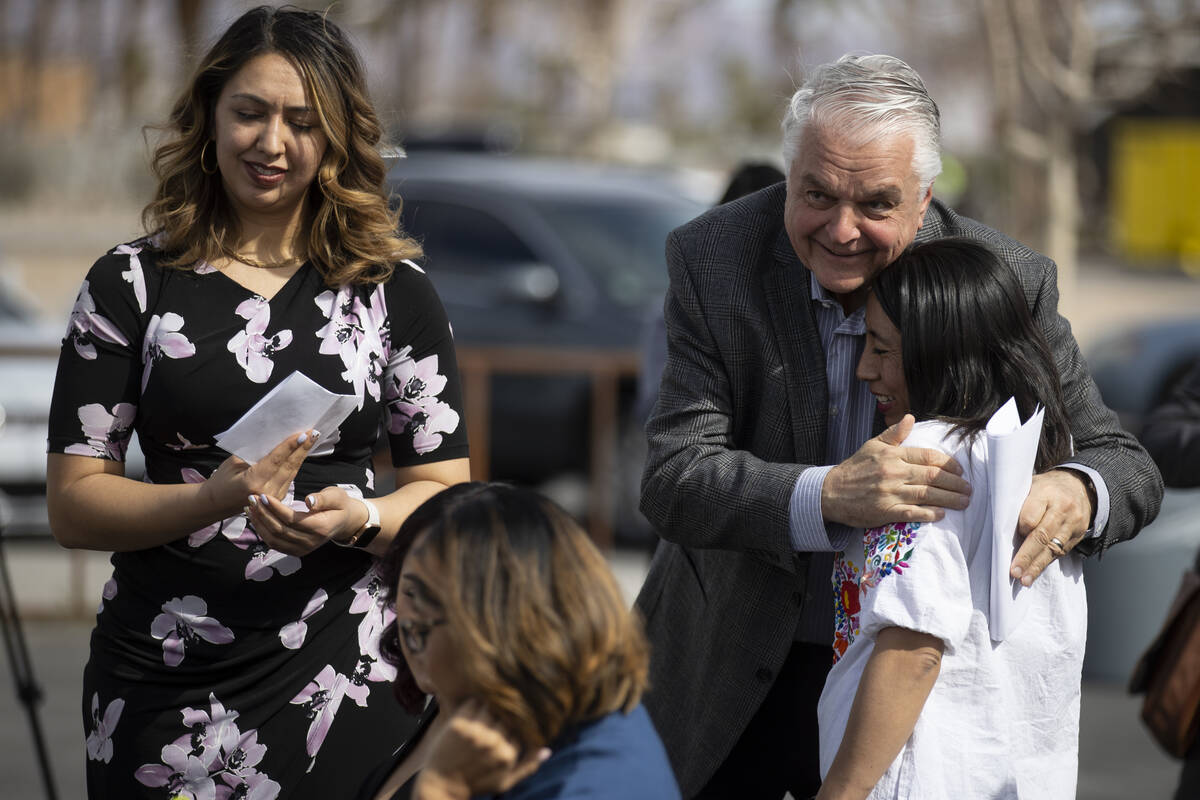 Gov. Steve Sisolak, right, embraces Elizabeth Velasquez, a client of the UNLV immigration clini ...