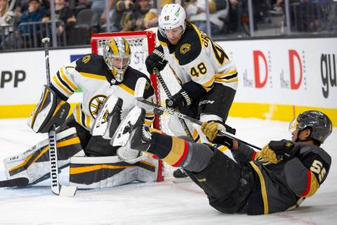 Golden Knights right wing Keegan Kolesar (55) falls to the ice while taking a shot on Bruins go ...