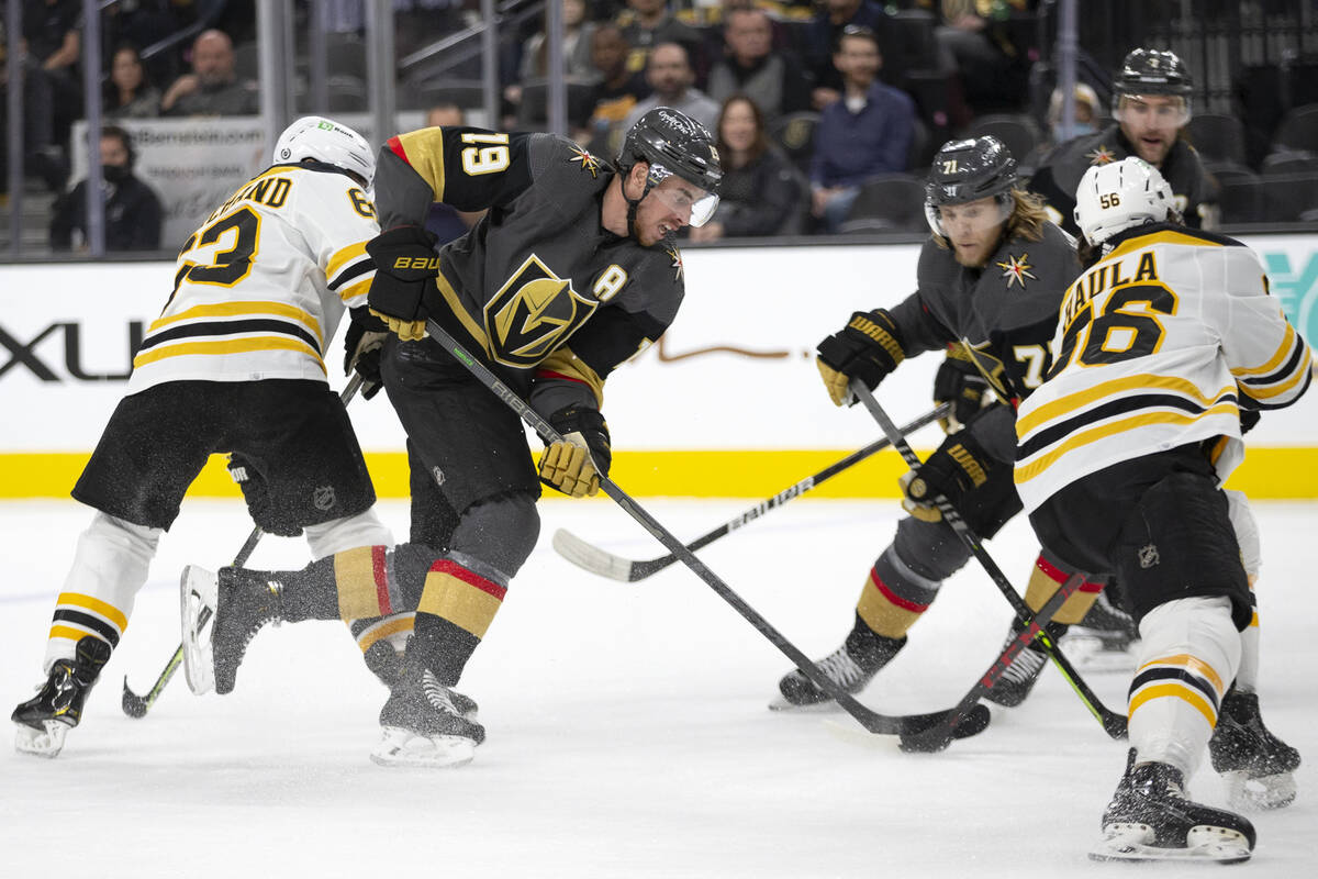 Golden Knights right wing Reilly Smith (19) and center William Karlsson (71) compete for the pu ...