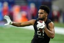 Ohio State wide receiver Chris Olave runs a drill during the NFL football scouting combine, Thu ...