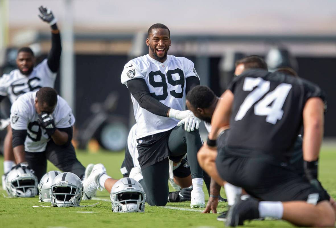 Raiders defensive end Clelin Ferrell (99) smiles while stretching during a practice session at ...