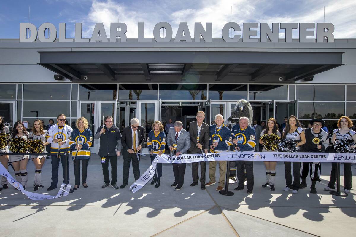 Dignitaries cut a ribbon beside arena staff during a ceremony for the new Dollar Loan Center on ...