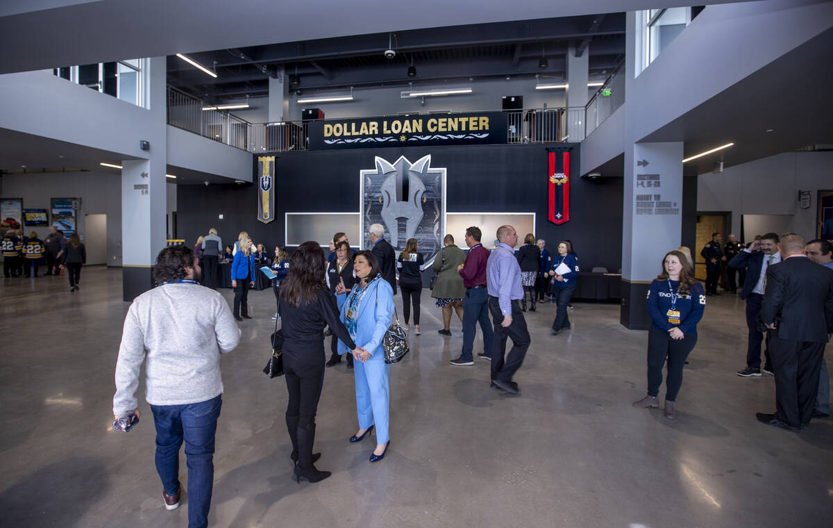 Attendees begin to flow through the entrance of the arena following a ribbon-cutting ceremony f ...