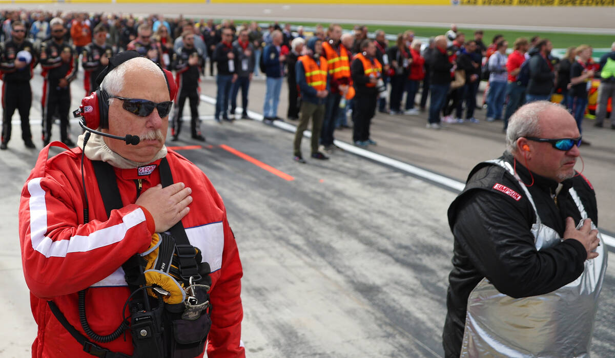 Race crews observe the national anthem before the start of the NASCAR Xfinity Series Alsco Unif ...