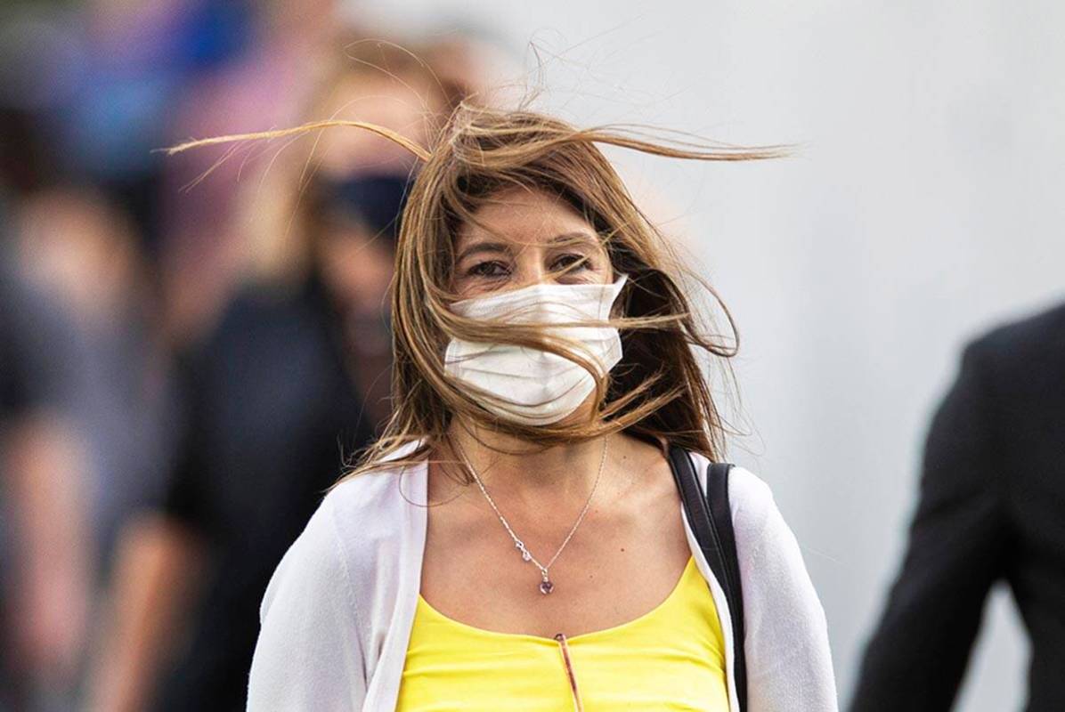 People brave high winds on the Strip on Monday, Oct. 11, 2021, in Las Vegas. A sunny sky with w ...