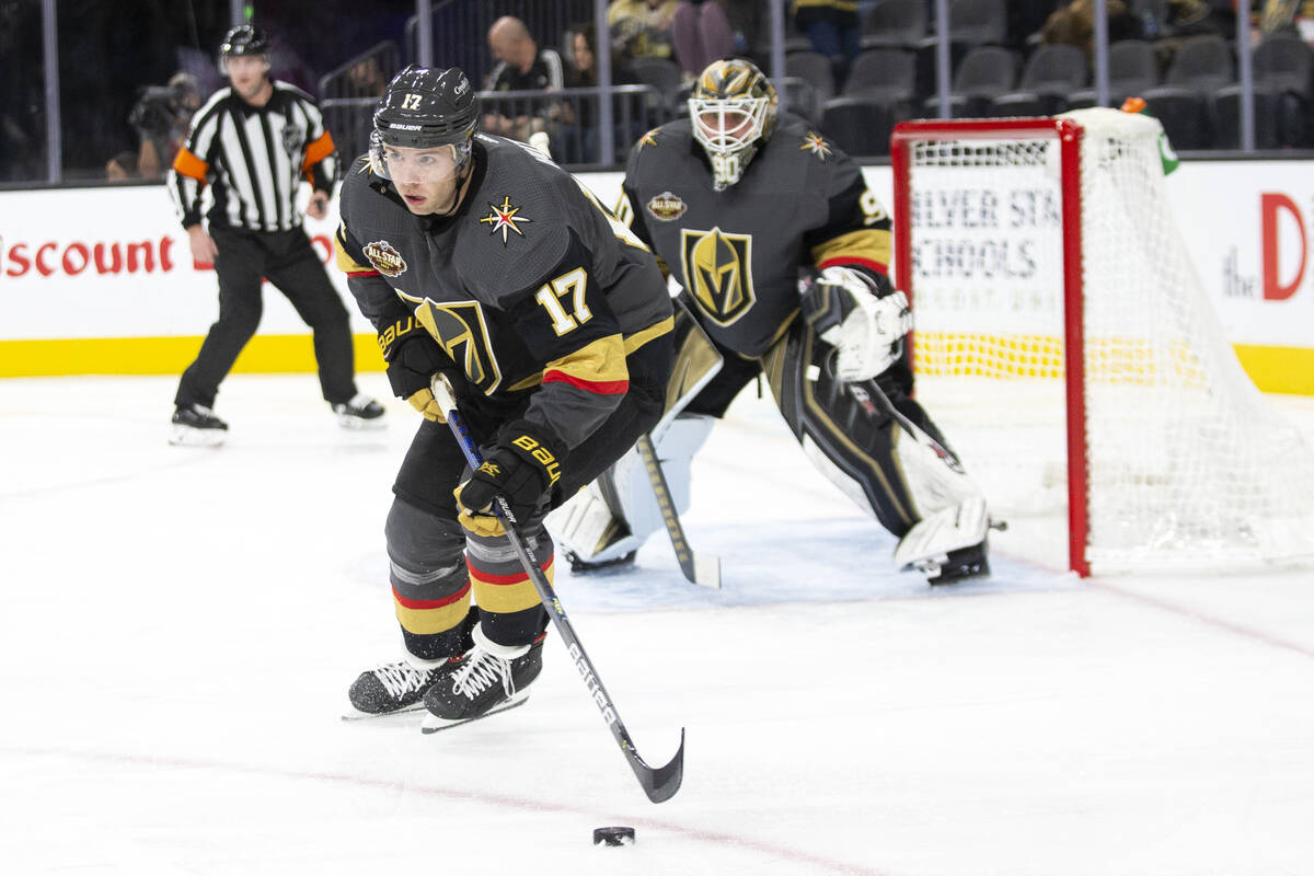 Golden Knights defenseman Ben Hutton (17) skates with the puck as goaltender Robin Lehner (90) ...