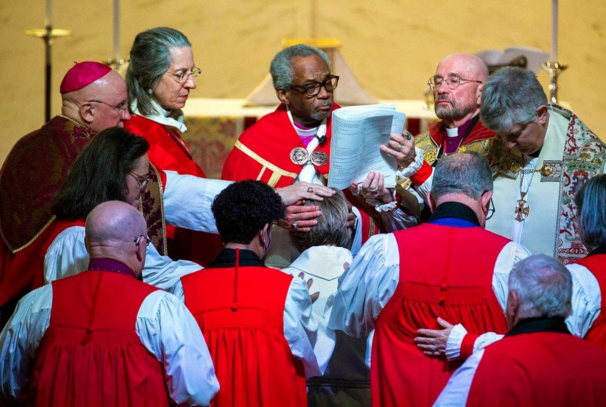 The Rev. Elizabeth Bonforte Gardner, center, has hands laid on her while presiding Bishop Micha ...