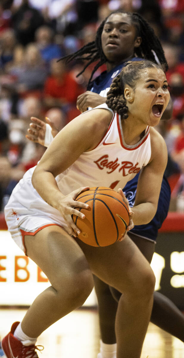 UNLV Lady Rebels forward Nneka Obiazor (1) grabs a rebound away from Nevada Wolf Pack guard Nia ...