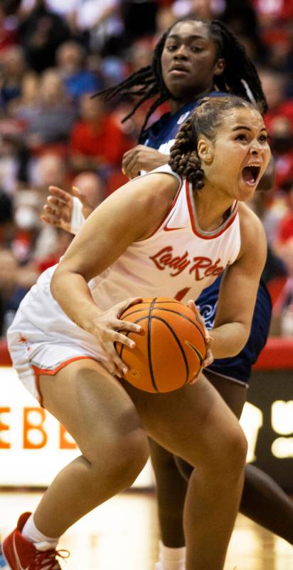 UNLV Lady Rebels forward Nneka Obiazor (1) grabs a rebound away from Nevada Wolf Pack guard Nia ...