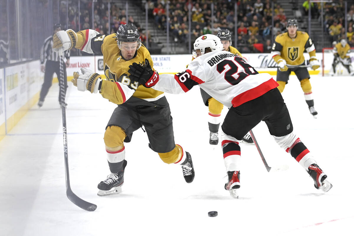 Vegas Golden Knights right wing Evgenii Dadonov (63) is defended by Ottawa Senators defenseman ...