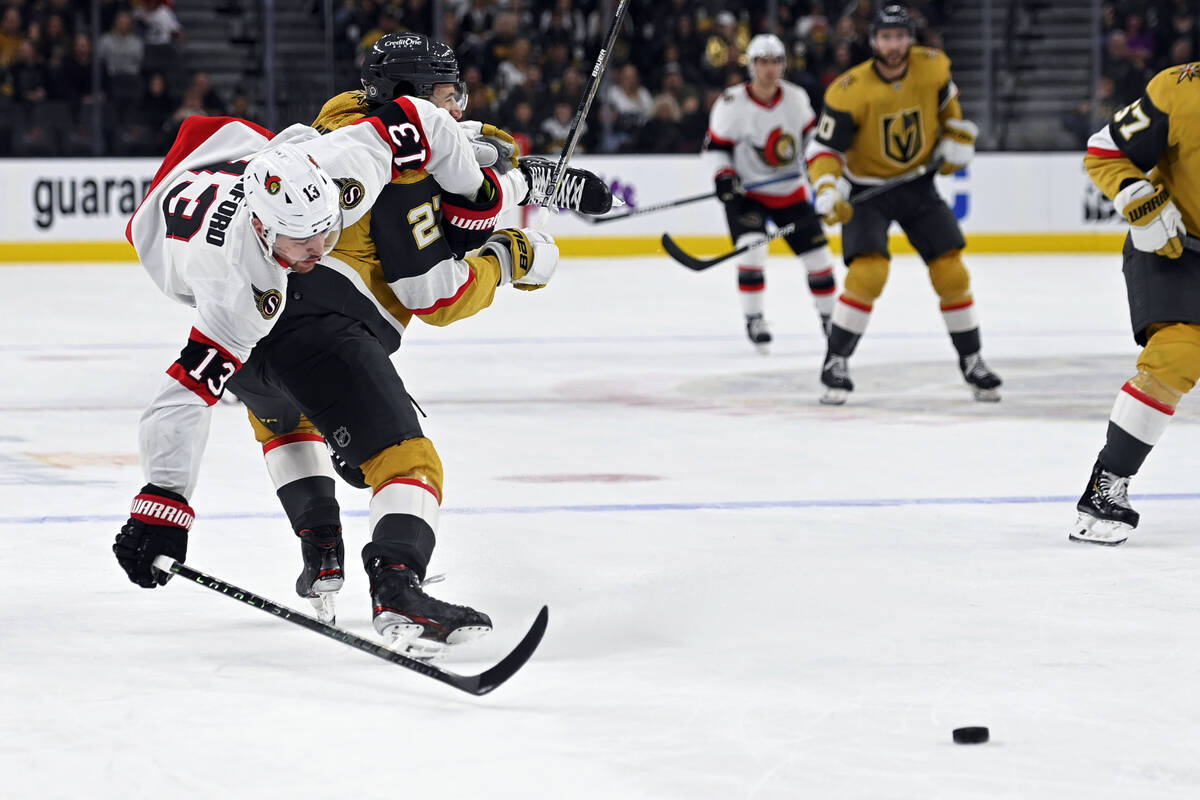 Ottawa Senators left wing Zach Sanford (13) rolls over the top of Vegas Golden Knights defensem ...