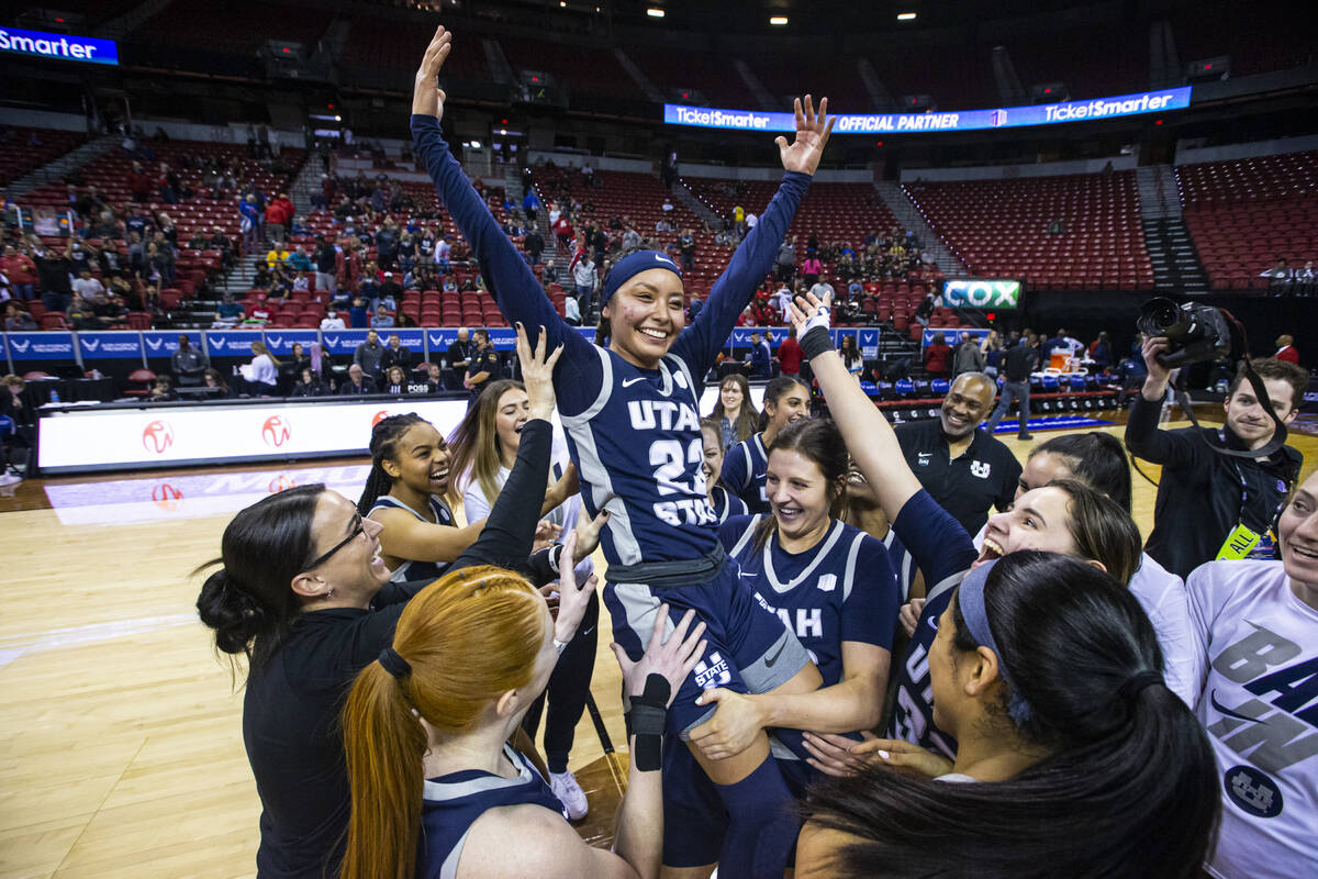 The Utah State Aggies celebrate with guard Shyla Latone (23) after defeating the Fresno State B ...