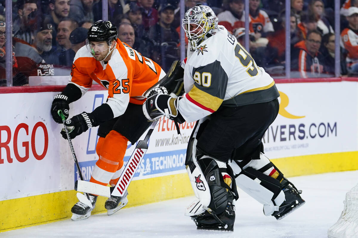 Vegas Golden Knights' Robin Lehner, right, clears the puck away from Philadelphia Flyers' James ...