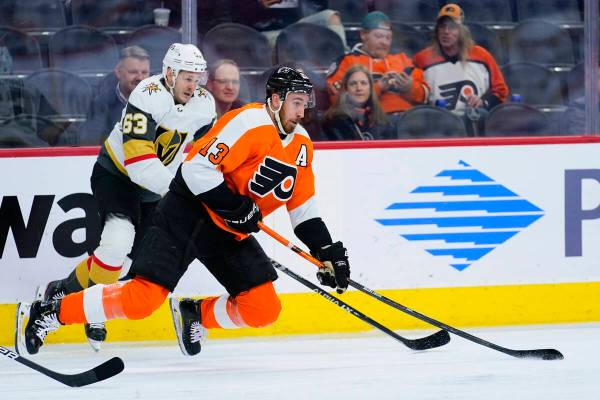 Philadelphia Flyers' Kevin Hayes, right, and Vegas Golden Knights' Evgenii Dadonov battle for t ...