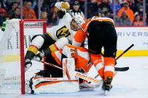 Vegas Golden Knights' Max Pacioretty, left, collides with Philadelphia Flyers' Carter Hart, cen ...