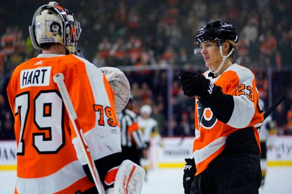 Philadelphia Flyers' Oskar Lindblom, right, and Carter Hart celebrate after a goal during the f ...