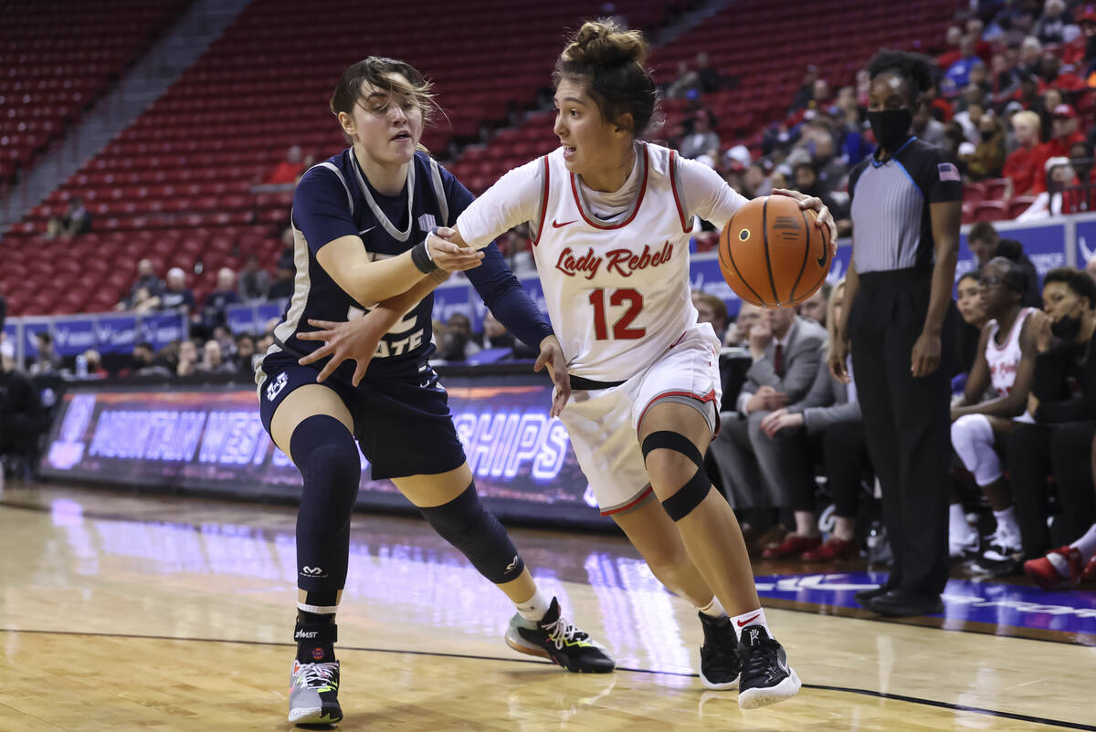 UNLV Lady Rebels guard Alyssa Durazo-Frescas (12) drives the ball around Utah State Aggies guar ...