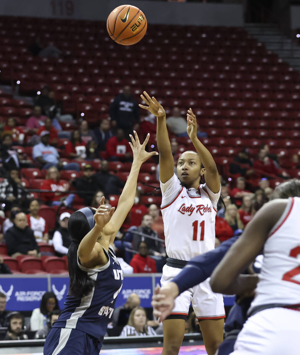 UNLV Lady Rebels guard Justice Ethridge (11) shoots over Utah State Aggies guard E'Lease Staffo ...