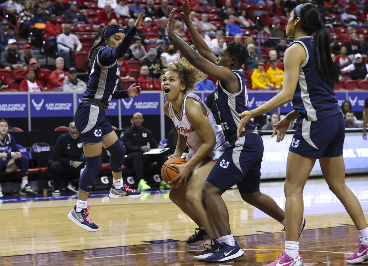 UNLV Lady Rebels forward Nneka Obiazor (1) looks to shoot as Utah State Aggies guards Shyla Lat ...