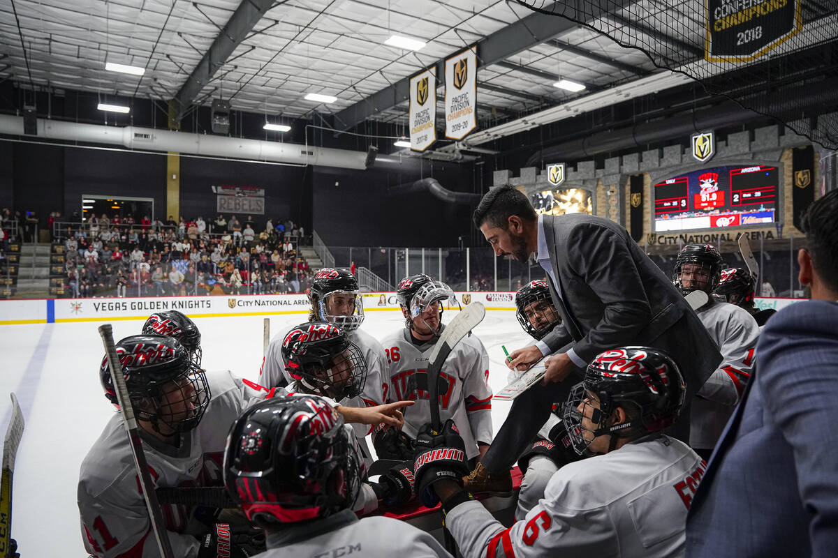 UNLV hockey assistant coach Nick Robone draws up a play for the team during one of its regular ...