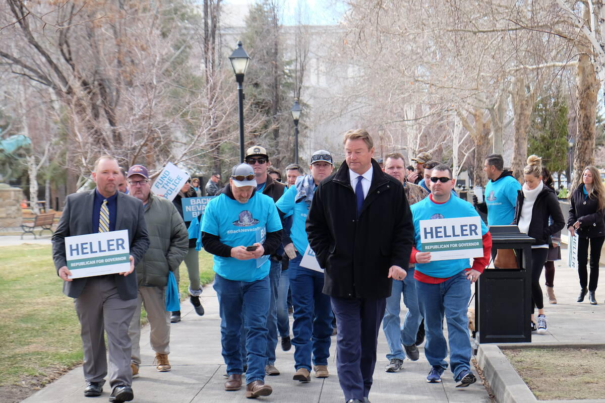 Dean Heller walks to the Capitol with supporters after a pro law enforcement rally to file his ...