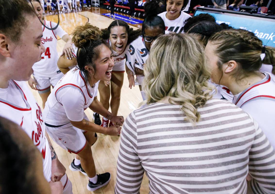 The UNLV Lady Rebels, including guard Alyssa Durazo-Frescas, center left, celebrate after defea ...