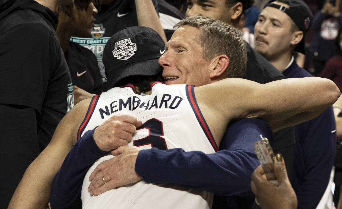 Gonzaga Bulldogs head coach Mark Few hugs Gonzaga Bulldogs center Chet Holmgren (34) after beat ...