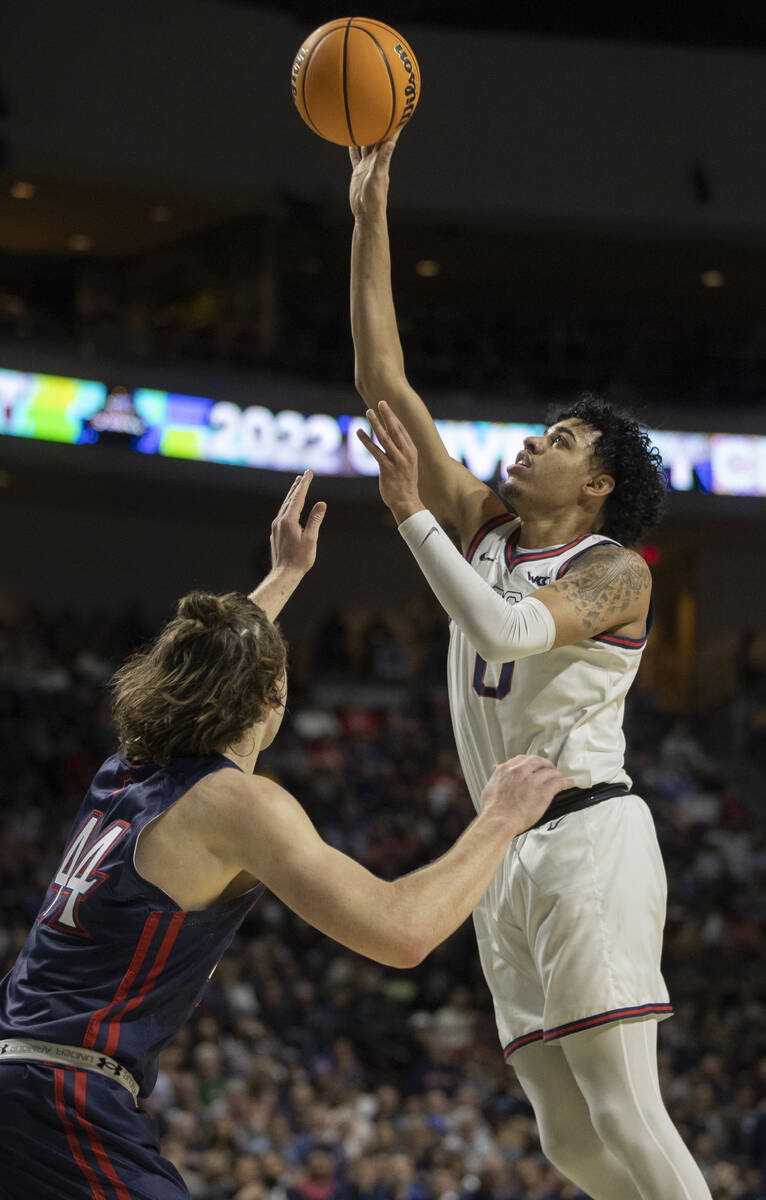 Gonzaga Bulldogs guard Julian Strawther (0) shoots over St. Mary's Gaels guard Alex Ducas (44) ...