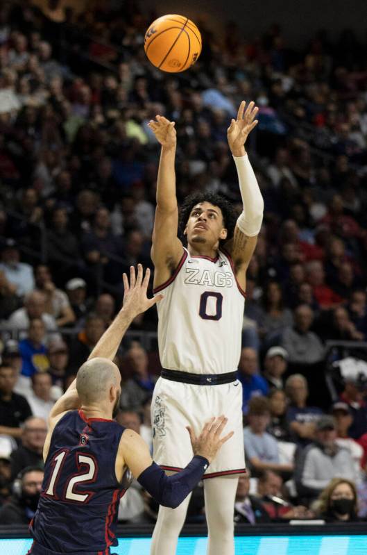 Gonzaga Bulldogs guard Julian Strawther (0) shoots over St. Mary's Gaels guard Tommy Kuhse (12) ...