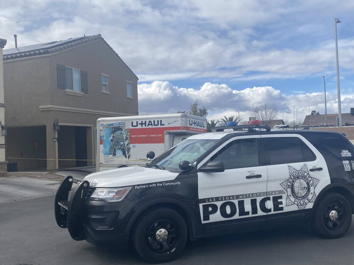 A police vehicle and a U-Haul truck are seen at a home on Wednesday, Feb. 23, 2022, a day after ...