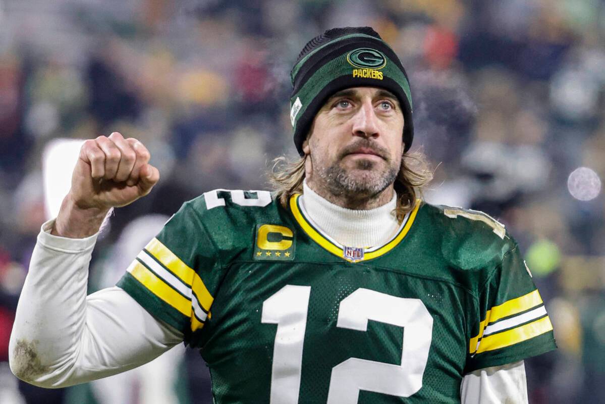 FILE - Green Bay Packers quarterback Aaron Rodgers (12) reacts as he leaves the field after an ...