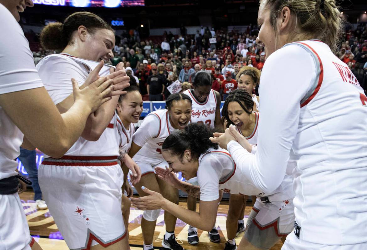 The UNLV Lady Rebels celebrate after defeating the Colorado State Rams 75-65 to win the Mountai ...