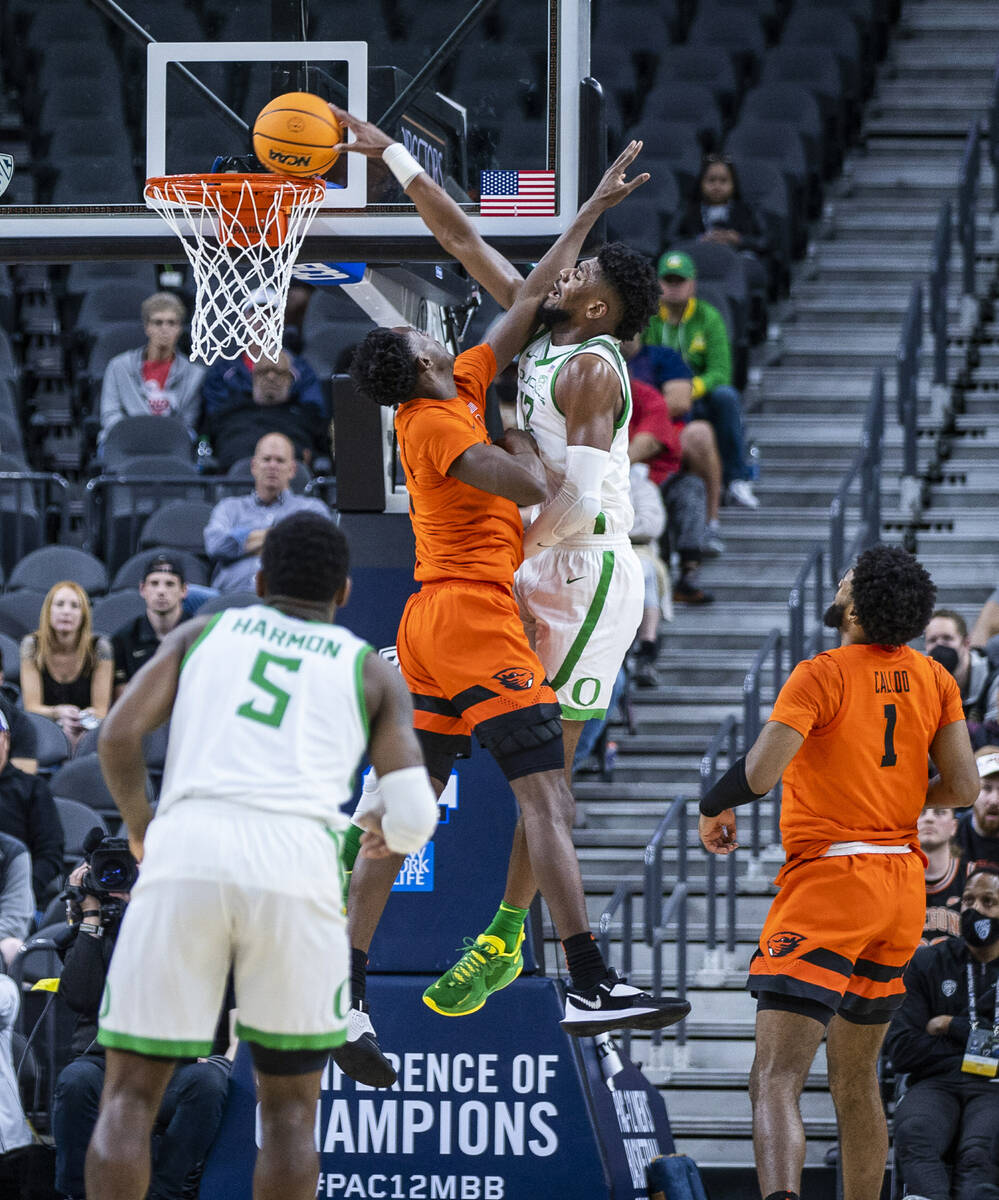 Oregon State Beavers forward Warith Alatishe (10) has the ball dunked over him by Oregon Ducks ...