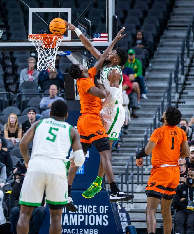 Oregon State Beavers forward Warith Alatishe (10) has the ball dunked over him by Oregon Ducks ...